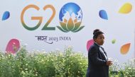 A security personnel gestures beside a hoarding during the G20 Foreign Minister meeting in New Delhi on March 2, 2023. (Photo by Arun SANKAR / AFP)
