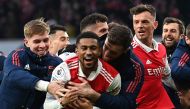 Arsenal's English midfielder Reiss Nelson (center) celebrates after scoring his team third goal of the team during the English Premier League match between Arsenal and Bournemouth at the Emirates Stadium in London on March 4, 2023. (Photo by Glyn KIRK / AFP) 