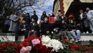 A photo shows flowers layed on the tracks at the railway station of Rapsani, north Greece, on March 5, 2023, during a commemorative gathering for the victims of a deadly train crash which killed 57. Photo by Sakis MITROLIDIS / AFP
