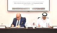 QU President Dr. Hassan Al Derham (right) and Academy President, Dr. Ramadan Al Madani signing the agreement.

