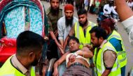Emergency personnel shift an injured man to the Dhaka Medical College Hospital in Dhaka on March 7, 2023, following an explosion inside an office building. (AFP)