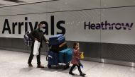 In this file photo taken on November 30, 2021 people arrive at Heathrow's Terminal 5 in west London. (AFP/Adrian Dennis)