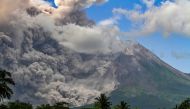 Thick smoke rises during an eruption from Mount Merapi, Indonesia痴 most active volcano, as seen from Tunggularum village in Sleman on March 11, 2023. (Photo by Devi Rahman / AFP)
 