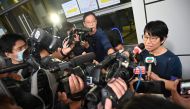 Elizabeth Tang Yin-ngor (right), secretary-general of the International Domestic Workers Federation, speaks to the media as she leaves the Wan Chai police headquarters in Hong Kong on March 11, 2023 after posting bail following her arrest on March 9, 2023 on suspicion of 