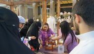 Visitors are intrigued by the craftmanship of making Bua Luang banana fabric during the Earthna Summit 2023 in Doha.