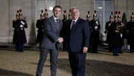 Fance's President Emmanuel Macron shakes hands with Hungarian Prime Minister Viktor Orban, before a working dinner at the Elysee Presidential Palace in Paris on March 13, 2023. (Photo by Ludovic MARIN / AFP)