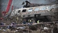 Police and emergency crew search the debris of a crushed wagon after a train accident in the Tempi Valley near Larisa, Greece, March 1, 2023. (Photo by Sakis Mitrolidis / AFP)