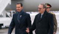 This handout picture released by the official Syrian Arab News Agency (SANA) shows Syria's President Bashar al-Assad being received by the Russia's Deputy Foreign Minister and the Russian president's special representative Mikhail Bogdanov upon arrival in Moscow on March 14, 2023. (Photo by SANA / AFP) 