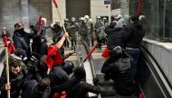 File photo: Protesters run from police into a metro station during a massive demonstration in Athens on March 5, 2023, following the deadly train accident late on February 28. (Photo by Louisa Gouliamaki / AFP)

