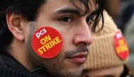 A demonstrator takes part in a protest called by the British trade union Public and Commercial Services Union (PCS) amid a dispute with the government over pay, outside Downing Street in London, on March 15, 2023. (Photo by JUSTIN TALLIS / AFP)