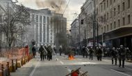 Police chases protesters in the center of the capital, as clashes broke out during a 24-hour strike in Athens on March 16, 2023. Photo by Louisa GOULIAMAKI / AFP