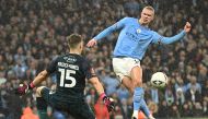 Manchester City's Norwegian striker Erling Haaland  scores their second goal past Burnley's Northern Irish goalkeeper Bailey Peacock-Farrell during the English FA Cup quarter-final football match between Manchester City and Burnley at the Etihad Stadium in Manchester, north-west England, on March 18, 2023. (Photo by Oli SCARFF / AFP)