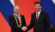 File Photo: Chinese President Xi Jinping congratulates Russian President Vladimir Putin after presenting him with the Friendship Medal in the Great Hall of the People in Beijing, China, June 8, 2018. (REUTERS)
