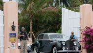 A security person stands at an entrance to former President Donald Trump's Mar-a-Lago home on March 19, 2023 in Palm Beach, Florida. Joe Raedle/Getty Images/AFP
