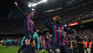 Barcelona's Ivorian midfielder Franck Kessie celebrates with teammates after scoring his team's second goal during the Spanish league football match between FC Barcelona and Real Madrid CF at the Camp Nou stadium in Barcelona on March 19, 2023. Photo by LLUIS GENE / AFP
