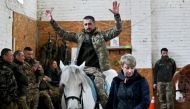  A Ukrainian serviceman rides a horse during a hippotherapy session in Kyiv on March 17, 2023. Photo by Sergei SUPINSKY / AFP