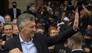 In this file photo taken on November 03, 2021, Argentina's former President Mauricio Macri waves after leaving the federal court in Dolores, Buenos Aires province. (Photo by JUAN MABROMATA / AFP)