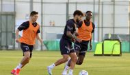 Al Duhail's South Korean midfielder Nam Tae-Hee (left) with teammates during a training session.