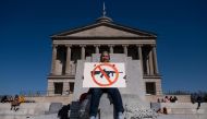 A protester sits with an anti-assault rifle sign near the Tennessee State Capitol to call for an end to gun violence and support stronger gun laws on March 30, 2023 in Nashville, Tennessee. (Photo by Seth Herald / GETTY IMAGES NORTH AMERICA / Getty Images via AFP)
