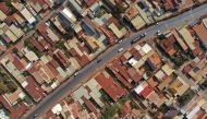 This aerial photograph taken on April 5, 2023 shows red dust on rooftops of communities near the construction site of Long Thanh airport in Dong Nai province. Photo by Nhac NGUYEN / AFP