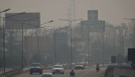 Commuters drive through high levels of air pollution in Chiang Mai on April 11, 2023. Photo by Lillian SUWANRUMPHA / AFP