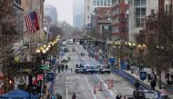 Workers clean the wet finish line during the 127th Boston Marathon in Boston, Massachusetts, on April 17, 2023. Photo by Joseph Prezioso / AFP