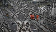 In this file photo taken on March 24, 2023 workers walk on train tracks of German railway operator Deutsche Bahn at the main railway station in Hagen, western Germany. Photo by INA FASSBENDER / AFP