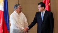 China's Foreign Minister Qin Gang (R) is welcomed by Philippine Foreign Secretary Enrique Manalo ahead of their meeting at the Diamond Hotel in Metro Manila on April 22, 2023. (Photo by Gerard CARREON / POOL / AFP)