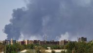 Smoke billows over buildings in Khartoum on May 1, 2023 as deadly clashes between rival generals' forces have entered their third week. Photo by AFP