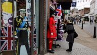 A woman looks at a merchandise shop selling royals souvenirs, in Windsor, on May 2, 2023, ahead of the coronation ceremony of Charles III and his wife, Camilla, as King and Queen of the United Kingdom and Commonwealth Realm nations, on May 6, 2023. Photo by Adrian DENNIS / AFP