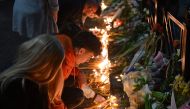 People light candles at a makeshift memorial for the victims following a shooting at a school in the Serbian capital Belgrade on May 3, 2023. Photo by ANDREJ ISAKOVIC / AFP