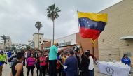 A group of Venezuelan migrants receive food and assistance from a local church in downtown Brownsville, Texas, on May 6, 2023. (Photo by Moisés VILA / AFP)
