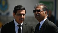Khawaja Haris (L) and Ali Zafar, members of the legal team of former Pakistan's Prime Minister Imran Khan, wait to attend a hearing near the police headquarters, in Islamabad on May 10, 2023. (Photo by Aamir Qureshi / AFP)