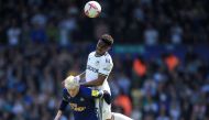 Leeds United's Spanish defender Junior Firpo heads the ball with Newcastle United's English midfielder Anthony Gordon (L) during the English Premier League football match between Leeds United and Newcastle United at Elland Road in Leeds, northern England on May 13, 2023. (Photo by Lindsey Parnaby / AFP) 