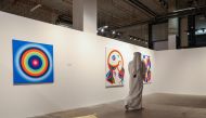 A visitor walks past the artworks at the Anima Gallery in Msheireb Downtown. 