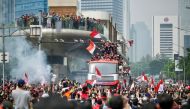 Fans attend a victory parade for Indonesia's football team in Jakarta on May 19, 2023, after they won the gold medal in the men's event at the 32nd Southeast Asian Games (SEA Games) in Phnom Penh. (Photo by Bay Ismoyo / AFP)