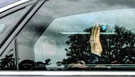 Former Italian premier Silvio Berlusconi waves from inside his car as he leaves on May 19, 2023 the San Raffaele hospital in Milan after being discharged. (Photo by Piero Cruciatti / AFP)