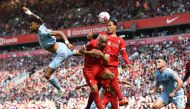 Aston Villa's English defender Tyrone Mings (L), Liverpool's Brazilian midfielder Fabinho (C) and Liverpool's Dutch defender Virgil van Dijk (2R) vie to header the ball during the English Premier League football match between Liverpool and Aston Villa at Anfield in Liverpool, north west England on May 20, 2023. (Photo by PETER POWELL / AFP) 