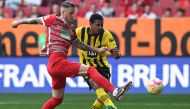 Dortmund's French forward Sebastien Haller (R) and Augsburg's Dutch defender Jeffrey Gouweleeuw vie for the ball during the German first division Bundesliga football match between FC Augsburg and BVB Borussia Dortmund in Augsburg, southern Germany, on May 21, 2023. (Photo by Christof STACHE / AFP)