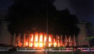 Firefighters douse a fire at the Post Office building in Manila on May 22, 2023. (Photo by AFP)
