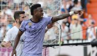 Real Madrid's Brazilian forward Vinicius Junior reacts to being insulted pointing at the stands during the Spanish league football match between Valencia CF and Real Madrid CF at the Mestalla stadium in Valencia on May 21, 2023. (Photo by Jose Jordan / AFP)

