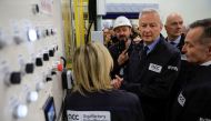 French Finance Minister Bruno Le Maire (C) visits the gigafactory of Automotive Cells Company (ACC), a joint venture of Stellantis, TotalEnergies and Mercedes, during its inauguration in Billy-Berclau-Douvrin, northern France, May 30, 2023. (Photo by Pascal Rossignol / POOL / AFP)