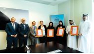Qatar Tourism officials with ISO certifications.