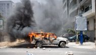 A car set ablaze by demonstrators is pictured in Dakar, on June 1, 2023 during a protest. (Photo by JOHN WESSELS / AFP)