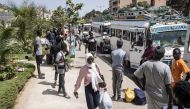Students carry their luggage as they leave the Cheikh Anta Diop University in Dakar, on June 2, 2023 after being closed due to the violent protests that broke out on University grounds. (Photo by John Wessels / AFP)