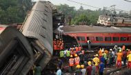 Rescue workers gather around damaged carriages at the accident site of a three-train collision near Balasore, about 200 km (125 miles) from the state capital Bhubaneswar in the eastern state of Odisha, on June 3, 2023. (Photo by Dibyangshu Sarkar / AFP)