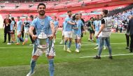Manchester City's German midfielder Ilkay Gundogan celebrates with the trophy on the pitch after the English FA Cup final football match between Manchester City and Manchester United at Wembley stadium, in London, on June 3, 2023. Man City won the game 2-1. (Photo by Glyn KIRK / AFP) 