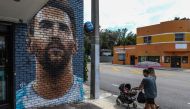 People walk in front of a mural depicting Argentine football player Lionel Messi in Miami on June 7, 2023. (Photo by Giorgio Viera / AFP)