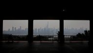 A pedestrian walks along the waterfront in West New York, New Jersey, across the Hudson River from Manhattan, as smoke haze from Canadian wildfires blankets the area. Photo by Leonardo Munoz / AFP