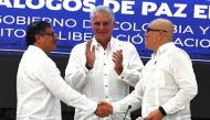 Colombian President Gustavo Petro (left) and ELN Guerrilla First Commander Antonio Garcia (right) shake hands next to Cuban President Miguel Diaz-Canel at the end of the closing of the Third Round of Peace Negotiation between the Colombian Government and the National Liberation Army (ELN) at El Laguito in Havana, on June 9, 2023. (Photo by Yamil Lage / AFP)
